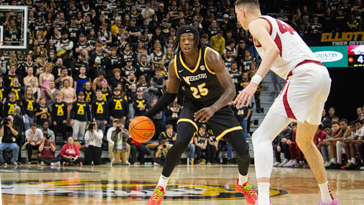 Jan. 18,  2025; Columbia, Missouri, USA; Missouri Tigers forward Mark Mitchell (25) looks to dribble past Zvonimir Ivišić (44) of the Arkansas Razorbacks during a game at Mizzou Arena. 