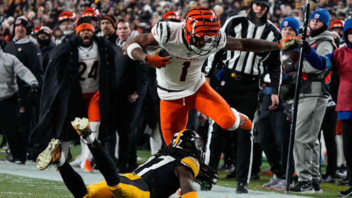 Bengals Ja'Marr Chase (1) leaps over a Steelers player during their game against the Steelers at Acrisure Stadium on Saturday January 4, 2025. The Bengals lead the game at halftime with a score of 13-7. Bengals Ja'Marr Chase (1) leaps over a Steelers player during their game against the Steelers at Acrisure Stadium on Saturday January 4, 2025. The Bengals lead the game at halftime with a score of 13-7.
