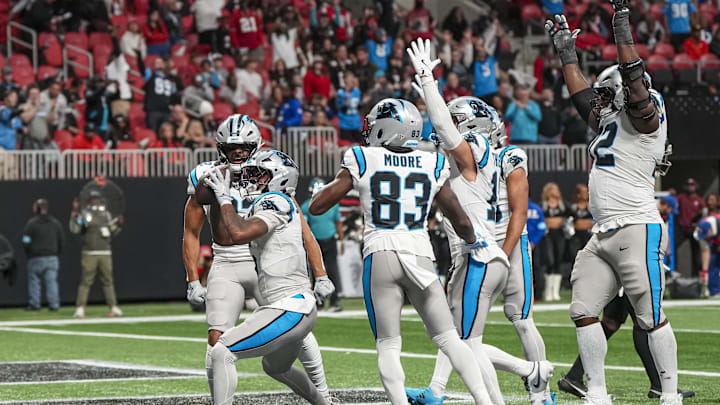 Jan 5, 2025; Atlanta, Georgia, USA; Carolina Panthers running back Miles Sanders (6) reacts with teammates after scoring the game winning touchdown against the Atlanta Falcons in overtime at Mercedes-Benz Stadium. Mandatory Credit: Dale Zanine-Imagn Images