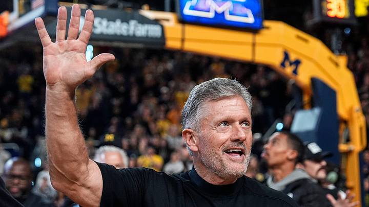 Michigan football head coach Kyle Whittingham waves at the crowd as he is being introduced on the floor during the first half between Michigan and USC at Crisler Center in Ann Arbor on Friday, Jan. 2, 2026. Michigan football head coach Kyle Whittingham waves at the crowd as he is being introduced on the floor during the first half between Michigan and USC at Crisler Center in Ann Arbor on Friday, Jan. 2, 2026.