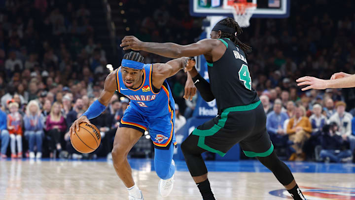 Jan 2, 2024; Oklahoma City, Oklahoma, USA; Oklahoma City Thunder guard Shai Gilgeous-Alexander (2) moves around Boston Celtics guard Jrue Holiday (4) during the second quarter at Paycom Center. Mandatory Credit: Alonzo Adams-Imagn Images