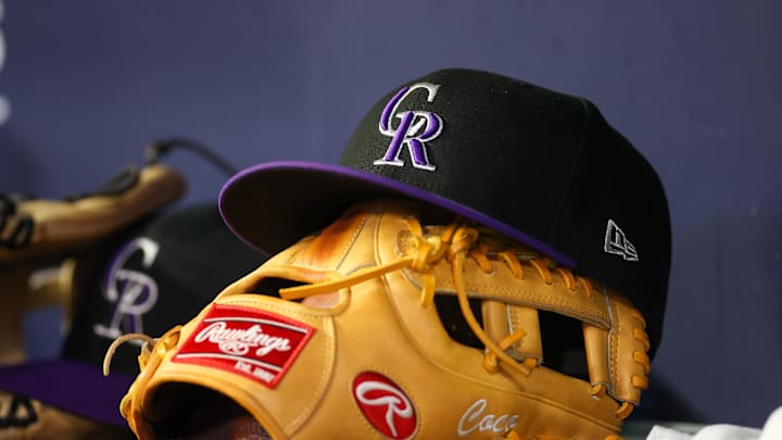Jun 15, 2023; Atlanta, Georgia, USA; A detailed view of a Colorado Rockies hat and glove on the bench against the Atlanta Braves in the ninth inning at Truist Park. Jun 15, 2023; Atlanta, Georgia, USA; A detailed view of a Colorado Rockies hat and glove on the bench against the Atlanta Braves in the ninth inning at Truist Park.