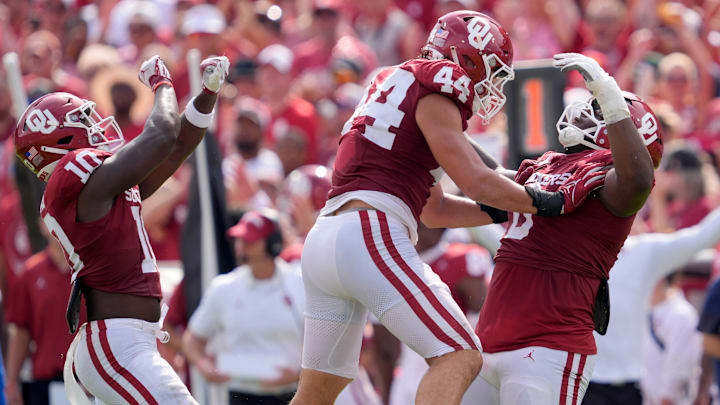 Oklahoma Sooners linebacker Kip Lewis (10), defensive lineman Taylor Wein (44) and defensive lineman David Stone (0) celebrate a stop against Auburn.