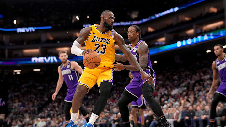 Dec 19, 2024; Sacramento, California, USA; Los Angeles Lakers forward LeBron James (23) dribbles the ball next to Sacramento Kings guard DeMar DeRozan (10) in the first quarter at the Golden 1 Center. Mandatory Credit: Cary Edmondson-Imagn Images