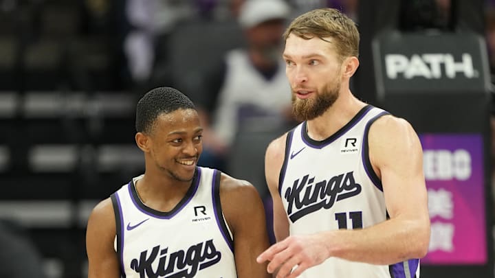 Dec 30, 2024; Sacramento, California, USA; Sacramento Kings guard De'Aaron Fox (5) and forward Domantas Sabonis (right) talk during the third quarter against the Dallas Mavericks at Golden 1 Center. Mandatory Credit: Darren Yamashita-Imagn Images