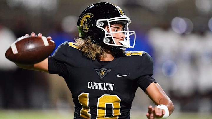Oct 20, 2023; Carrollton, GA, USA; Carrollton Trojans quarterback Julian Lewis (10) drops back to pass against the Westlake Lions during the first half at Grisham Stadium. The 15-year-old Carrollton High student has already committed to playing for the University of Southern California Trojans and has been considered one of the top high school quarterback prospects. Mandatory Credit: John David Mercer-Imagn Images
