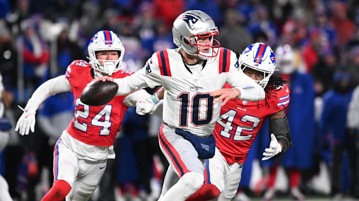 Dec 22, 2024; Orchard Park, New York, USA; New England Patriots quarterback Drake Maye (10) throws a pass under pressure from Buffalo Bills safety Cole Bishop (24) and linebacker Dorian Williams (42) in the fourth quarter at Highmark Stadium. Mandatory Credit: Mark Konezny-Imagn Images