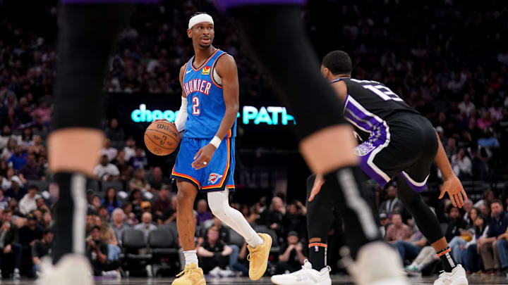 Mar 25, 2025; Sacramento, California, USA; Oklahoma City Thunder guard Shai Gilgeous-Alexander (2) dribbles the ball next to Sacramento Kings forward Keegan Murray (13) in the third quarter at the Golden 1 Center. Mandatory Credit: Cary Edmondson-Imagn Images
