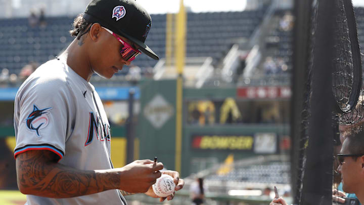 Sep 11, 2024; Pittsburgh, Pennsylvania, USA;  Miami Marlins center fielder Cristian Pache (20) signs autographs before a game against the Pittsburgh Pirates at PNC Park. Mandatory Credit: Charles LeClaire-Imagn Images