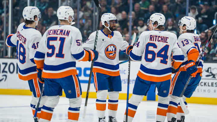 Jan 21, 2026; Seattle, Washington, USA; New York Islanders forward Anthony Duclair (11), center, celebrates a goal with defenseman Matthew Schaefer (48), forward Emil Heineman (51), forward Calum Ritchie (64) and forward Mathew Barzal (13) during the first period at Climate Pledge Arena. Mandatory Credit: Stephen Brashear-Imagn Images