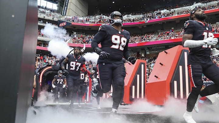 Dec 15, 2024; Houston, Texas, USA; Houston Texans defensive tackle Tim Settle Jr. (98) runs onto the field before the game against the Miami Dolphins at NRG Stadium. Mandatory Credit: Troy Taormina-Imagn Images