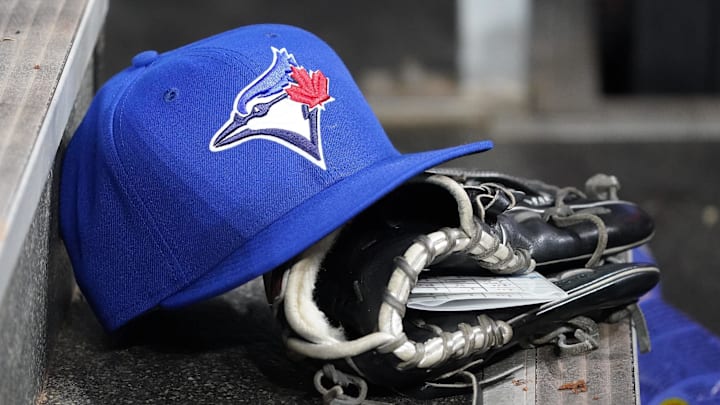 Apr 16, 2025; Toronto, Ontario, CAN; A Toronto Blue Jays hat and glove in the dugout during a game against the Atlanta Braves at Rogers Centre. 