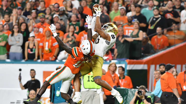Nov 11, 2017; Miami Gardens, FL, USA; Notre Dame Fighting Irish tight end Alize Mack (86) catches a pass for a touchdown over Miami Hurricanes cornerback Malek Young (12) in the third quarter at Hard Rock Stadium. 
