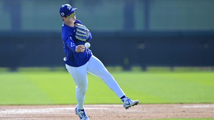 Feb 18, 2025; Glendale, AZ, USA;  Los Angeles Dodgers second baseman Hyeseong Kim (6) fields ground balls during spring training workouts at Camelback Ranch. Mandatory Credit: Jayne Kamin-Oncea-Imagn Images