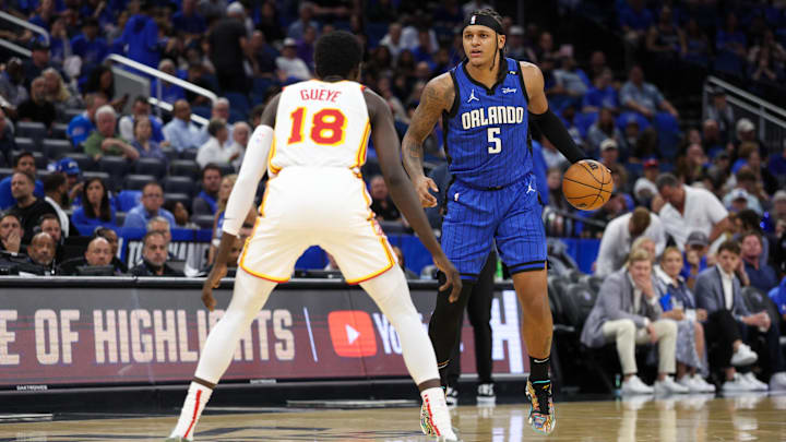 Orlando Magic forward Paolo Banchero (5) is guarded by Atlanta Hawks forward Mouhamed Gueye (18) in the third quarter at Kia Center. Orlando Magic forward Paolo Banchero (5) is guarded by Atlanta Hawks forward Mouhamed Gueye (18) in the third quarter at Kia Center.