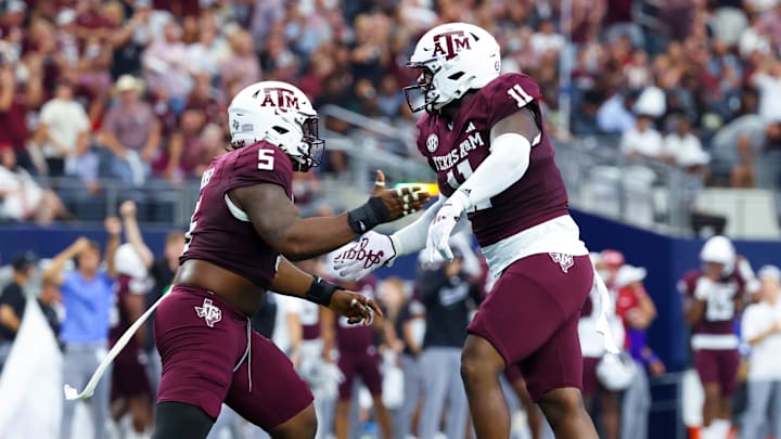 Sep 28, 2024; Arlington, Texas, USA;  Texas A&M Aggies defensive lineman Nic Scourton (11) celebrates with Texas A&M Aggies defensive lineman Shemar Turner (5) during the first half against the Arkansas Razorbacks at AT&T Stadium. Mandatory Credit: Kevin Jairaj-Imagn Images