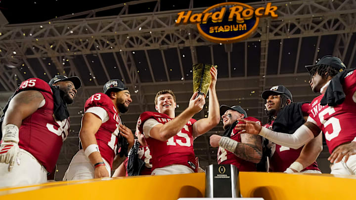 Indiana Hoosiers quarterback Fernando Mendoza (15) hoists the championship trophy Monday, Jan. 19, 2026, after defeating the Miami (FL) Hurricanes in the College Football Playoff National Championship college football game at Hard Rock Stadium in Miami Gardens.
