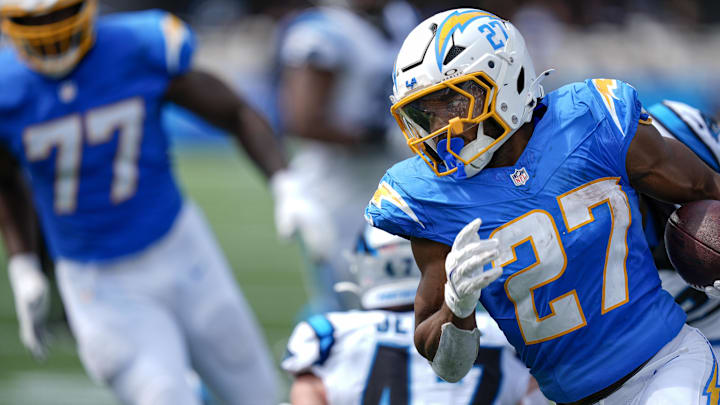 Sep 15, 2024; Charlotte, North Carolina, USA;  Los Angeles Chargers running back J.K. Dobbins (27) turns the corner away from Carolina Panthers linebacker Josey Jewell (47) for a touchdown run during the second quarter at Bank of America Stadium. 
