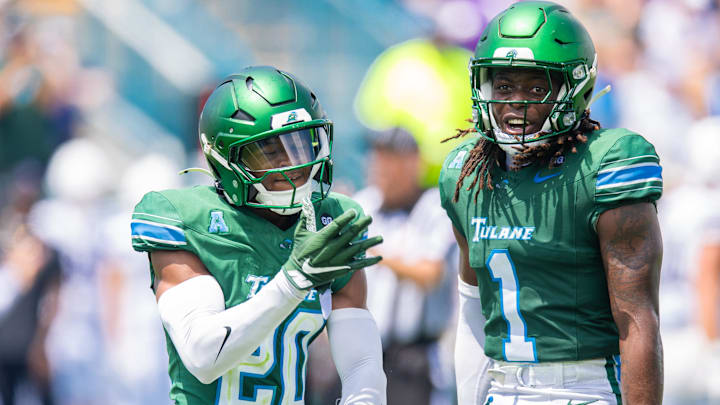 Aug 30, 2025; New Orleans, Louisiana, USA;  Tulane Green Wave defensive back Jahiem Johnson (20) and Tulane Green Wave safety Jack Tchienchou (1) react to a play against Northwestern Wildcats during the second half at Yulman Stadium. Mandatory Credit: Stephen Lew-Imagn Images