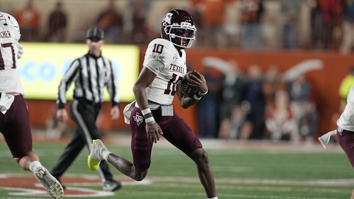 Nov 28, 2025; Austin, Texas, USA; Texas A&M Aggies quarterback Marcel Reed (10) keeps the ball for yards during the first half against the Texas Longhorns at Darrell K Royal-Texas Memorial Stadium. Mandatory Credit: Scott Wachter-Imagn Images