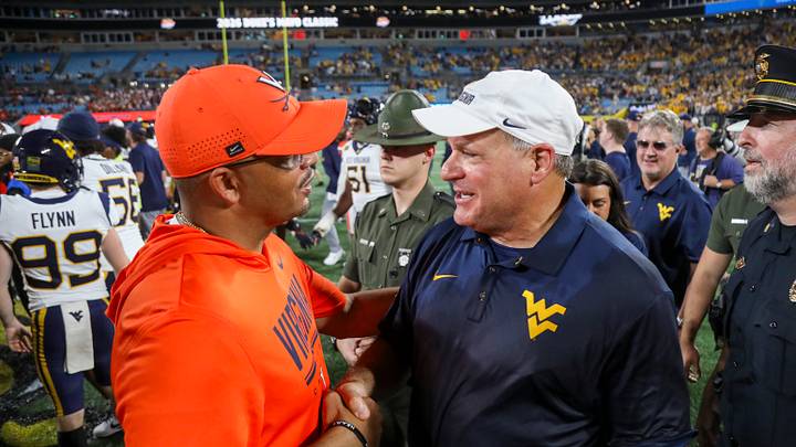 Sep 19, 2026; Charlotte, North Carolina, USA; West Virginia Mountaineers head coach Rich Rodriguez talks with Virginia Cavaliers head coach Tony Elliott after the game at Bank of America Stadium. Mandatory Credit: Ben Queen-Imagn Images Sep 19, 2026; Charlotte, North Carolina, USA; West Virginia Mountaineers head coach Rich Rodriguez talks with Virginia Cavaliers head coach Tony Elliott after the game at Bank of America Stadium. Mandatory Credit: Ben Queen-Imagn Images