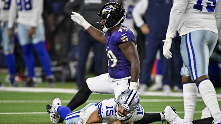 Aug 16, 2025; Arlington, Texas, USA; Baltimore Ravens linebacker Jay Higgins IV (49) sacks Dallas Cowboys quarterback Will Grier (15) during the second half at AT&T Stadium. Mandatory Credit: Jerome Miron-Imagn Images