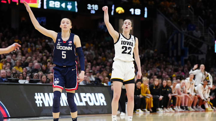 Apr 5, 2024; Cleveland, OH, USA; Iowa Hawkeyes guard Caitlin Clark (22) and Connecticut Huskies guard Paige Bueckers (5) react in the second quarter in the semifinals of the Final Four of the womens 2024 NCAA Tournament at Rocket Mortgage FieldHouse. Mandatory Credit: Kirby Lee-Imagn Images