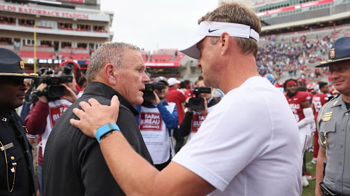 Arkansas Razorbacks head coach Sam Pittman shakes hands with Ole Miss Rebels head coach Lane Kiffin after the game at Donald W. Reynolds Razorback Stadium. Mississippi won 63-31.