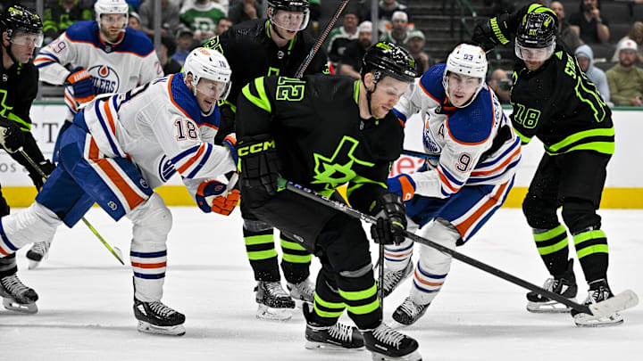 Apr 3, 2024; Dallas, Texas, USA; Dallas Stars center Radek Faksa (12) keeps the puck away from Edmonton Oilers left wing Zach Hyman (18) and left wing Evander Kane (91) during the third period at the American Airlines Center. Mandatory Credit: Jerome Miron-USA TODAY Sports
