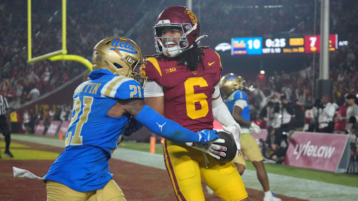Nov 29, 2025; Los Angeles, California, USA; Southern California Trojans wide receiver Makai Lemon (6) catches a 32-yard touchdown pass against UCLA Bruins defensive back Kanye Clark (1) in the second half at United Airlines Field at Los Angeles Memorial Coliseum. Mandatory Credit: Kirby Lee-Imagn Images Nov 29, 2025; Los Angeles, California, USA; Southern California Trojans wide receiver Makai Lemon (6) catches a 32-yard touchdown pass against UCLA Bruins defensive back Kanye Clark (1) in the second half at United Airlines Field at Los Angeles Memorial Coliseum. Mandatory Credit: Kirby Lee-Imagn Images