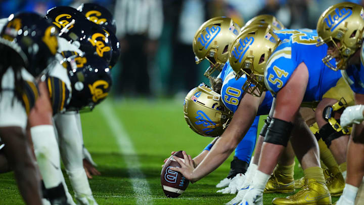 Nov 25, 2023; Pasadena, California, USA; Helmets at the line of scrimmage as UCLA Bruins long snapper Beau Gardner (60) snaps the ball against the California Golden Bears at the Rose Bowl. Mandatory Credit: Kirby Lee-Imagn Images