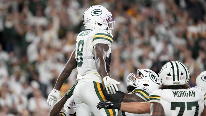 Green Bay Packers running back Josh Jacobs (8) celebrates with teammates after scoring a touchdown against the Commanders. Green Bay Packers running back Josh Jacobs (8) celebrates with teammates after scoring a touchdown against the Commanders.