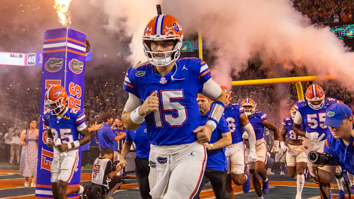Florida Gators quarterback Graham Mertz (15) runs out of the tunnel with the team as fireworks and fire shoot out of towers before the start of the game at Ben Hill Griffin Stadium in Gainesville, FL on Saturday, October 5, 2024. [Doug Engle/Gainesville Sun]
