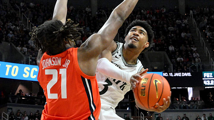 Jan 19, 2025; East Lansing, Michigan, USA;  Michigan State Spartans guard Jaden Akins (3) drives into the paint against Illinois Fighting Illini forward Morez Johnson Jr. (21) during the second half at Jack Breslin Student Events Center. Mandatory Credit: Dale Young-Imagn Images