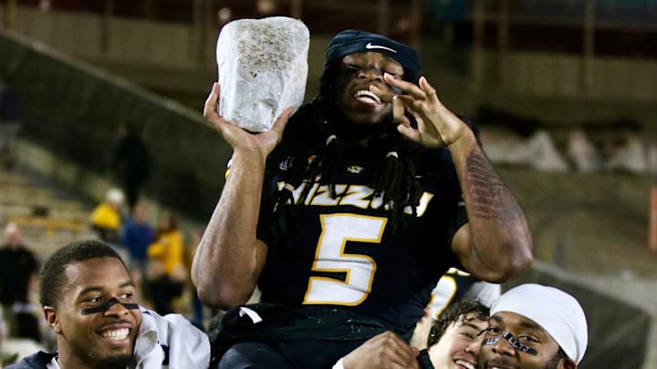 Nov 15, 2025; Columbia, Missouri, USA; Linebackers Josiah Trotter and Jeremiah Beasley carry senior linebacker Khalil Jacobs off the field after taking his rock.