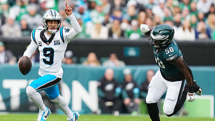 PHILADELPHIA, PENNSYLVANIA - DECEMBER 08: Bryce Young #9 of the Carolina Panthers runs the ball against Jalyx Hunt #58 of the Philadelphia Eagles in the second quarter of a game at Lincoln Financial Field on December 08, 2024 in Philadelphia, Pennsylvania.