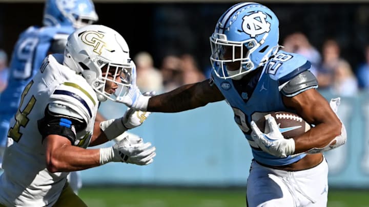 Oct 12, 2024; Chapel Hill, North Carolina, USA; North Carolina Tar Heels running back Omarion Hampton (28) with the ball as Georgia Tech Yellow Jackets linebacker Kyle Efford (44) defends in the fourth quarter at Kenan Memorial Stadium. / Bob Donnan-Imagn Images