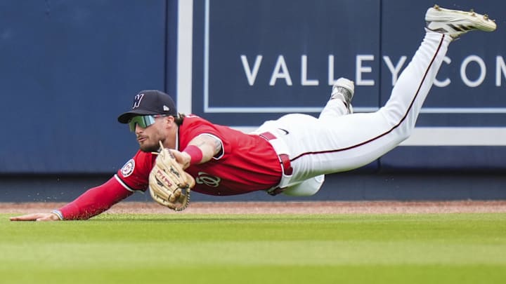 Mar 4, 2025; West Palm Beach, Florida, USA; Washington Nationals outfielder Dylan Crews (3) catches a fly ball for an out against the St. Louis Cardinals during the second inning at CACTI Park of the Palm Beaches. 