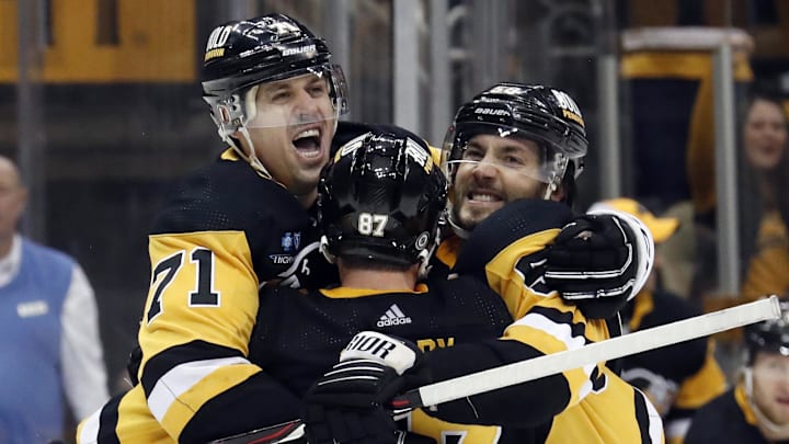 Mar 12, 2023; Pittsburgh, Pennsylvania, USA; Pittsburgh Penguins center Sidney Crosby (87) and center Evgeni Malkin (71) and defenseman Kris Letang (right) celebrate a game winning goal in overtime by Letang to defeat the New York Rangers at PPG Paints Arena. The Penguins won 3-2 in overtime. Mandatory Credit: Charles LeClaire-Imagn Images