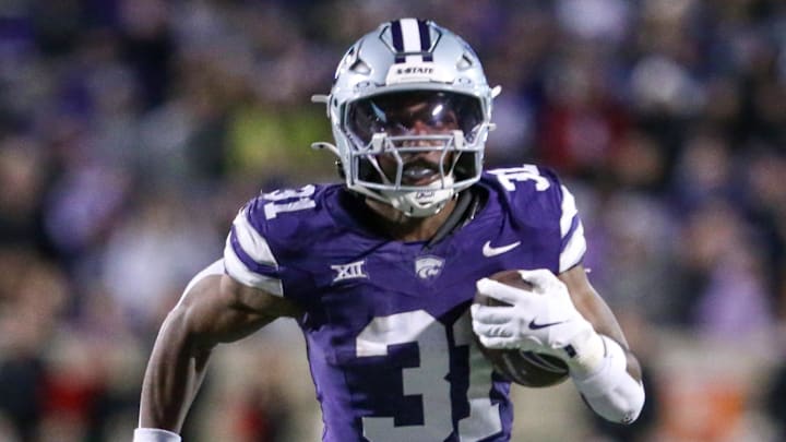 Nov 23, 2024; Manhattan, Kansas, USA; Kansas State Wildcats running back DJ Giddens (31) finds room to run during the fourth quarter against the Cincinnati Bearcats at Bill Snyder Family Football Stadium. Mandatory Credit: Scott Sewell-Imagn Images Nov 23, 2024; Manhattan, Kansas, USA; Kansas State Wildcats running back DJ Giddens (31) finds room to run during the fourth quarter against the Cincinnati Bearcats at Bill Snyder Family Football Stadium. Mandatory Credit: Scott Sewell-Imagn Images