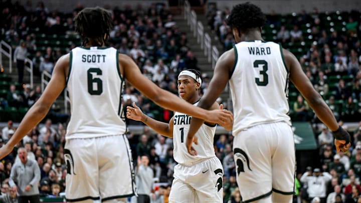 Michigan State's Jeremy Fears Jr., center, slaps hands with Jordan Scott, left, and Cam Ward, right, during the second half against Toledo on Tuesday, Dec. 16, 2025, at the Breslin Center in East Lansing.