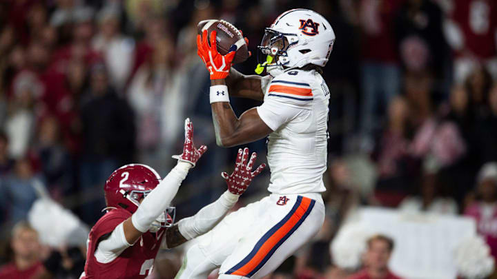 Auburn Tigers wide receiver Cam Coleman (8) catches a touchdown pass over Alabama Crimson Tide defensive back Zabien Brown (2)