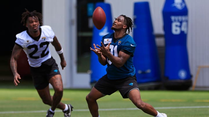 Jacksonville Jaguars running back Keilan Robinson (31) catches a punt as cornerback Jarrian Jones (22) looks on during an organized team activity Tuesday, May 28, 2024 at EverBank Stadium’s Miller Electric Center in Jacksonville, Fla.