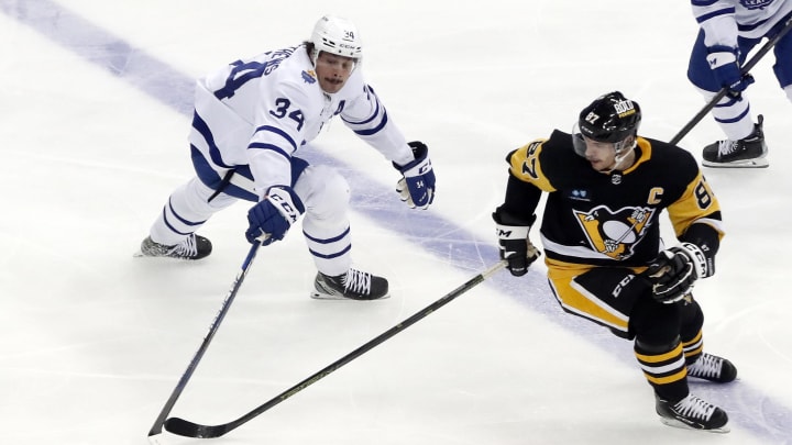 Nov 26, 2022; Pittsburgh, Pennsylvania, USA; Toronto Maple Leafs center Auston Matthews (34) and Pittsburgh Penguins center Sidney Crosby (87) reach for the puck during the third period at PPG Paints Arena. Toronto won 4-1. Mandatory Credit: Charles LeClaire-USA TODAY Sports Nov 26, 2022; Pittsburgh, Pennsylvania, USA; Toronto Maple Leafs center Auston Matthews (34) and Pittsburgh Penguins center Sidney Crosby (87) reach for the puck during the third period at PPG Paints Arena. Toronto won 4-1. Mandatory Credit: Charles LeClaire-USA TODAY Sports