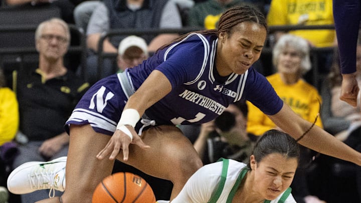 Oregon’s Ari Long, right, draws a player control foul against Northwestern’s Xamiya Walton during the first half at Matthew Knight Arena Jan. 1, 2026. Oregon’s Ari Long, right, draws a player control foul against Northwestern’s Xamiya Walton during the first half at Matthew Knight Arena Jan. 1, 2026.
