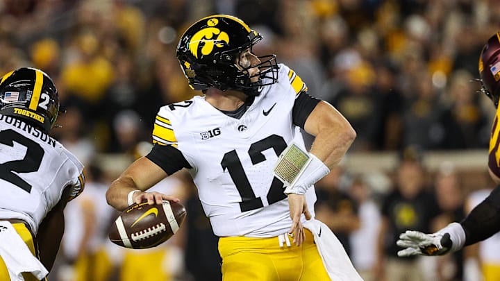 Sep 21, 2024; Minneapolis, Minnesota, USA; Iowa Hawkeyes quarterback Cade McNamara (12) throws the ball against the Minnesota Golden Gophers during the second half at Huntington Bank Stadium. Sep 21, 2024; Minneapolis, Minnesota, USA; Iowa Hawkeyes quarterback Cade McNamara (12) throws the ball against the Minnesota Golden Gophers during the second half at Huntington Bank Stadium.