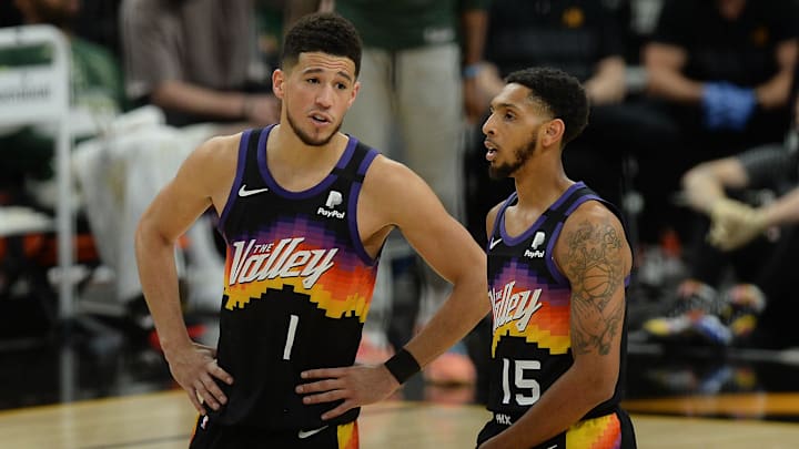 Jul 8, 2021; Phoenix, Arizona, USA; Phoenix Suns guard Devin Booker (1) speaks with guard Cameron Payne (15) during the second half in game two of the 2021 NBA Finals at Phoenix Suns Arena. Mandatory Credit: Joe Camporeale-Imagn Images