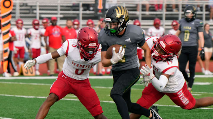 Viera's Eric Nelson scampers between Seabreeze's Xavier Lucas (6) and Denzel Shropshire (19) during Kickoff Classic at New Smyrna Beach Sports Park, Friday, Aug.18, 2023.