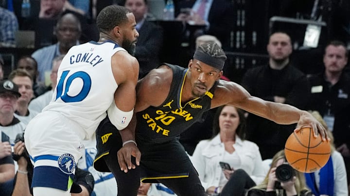 Minnesota Timberwolves guard Mike Conley defends Golden State Warriors forward Jimmy Butler in the first quarter of Game 1 of a Western Conference semifinal at Target Center in Minneapolis on May 6, 2025. 