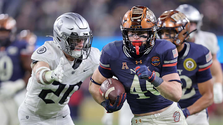 Navy Midshipmen slotback Justin Brown (46) runs the ball against the Army Black Knights during the second half of the 126th Army-Navy game